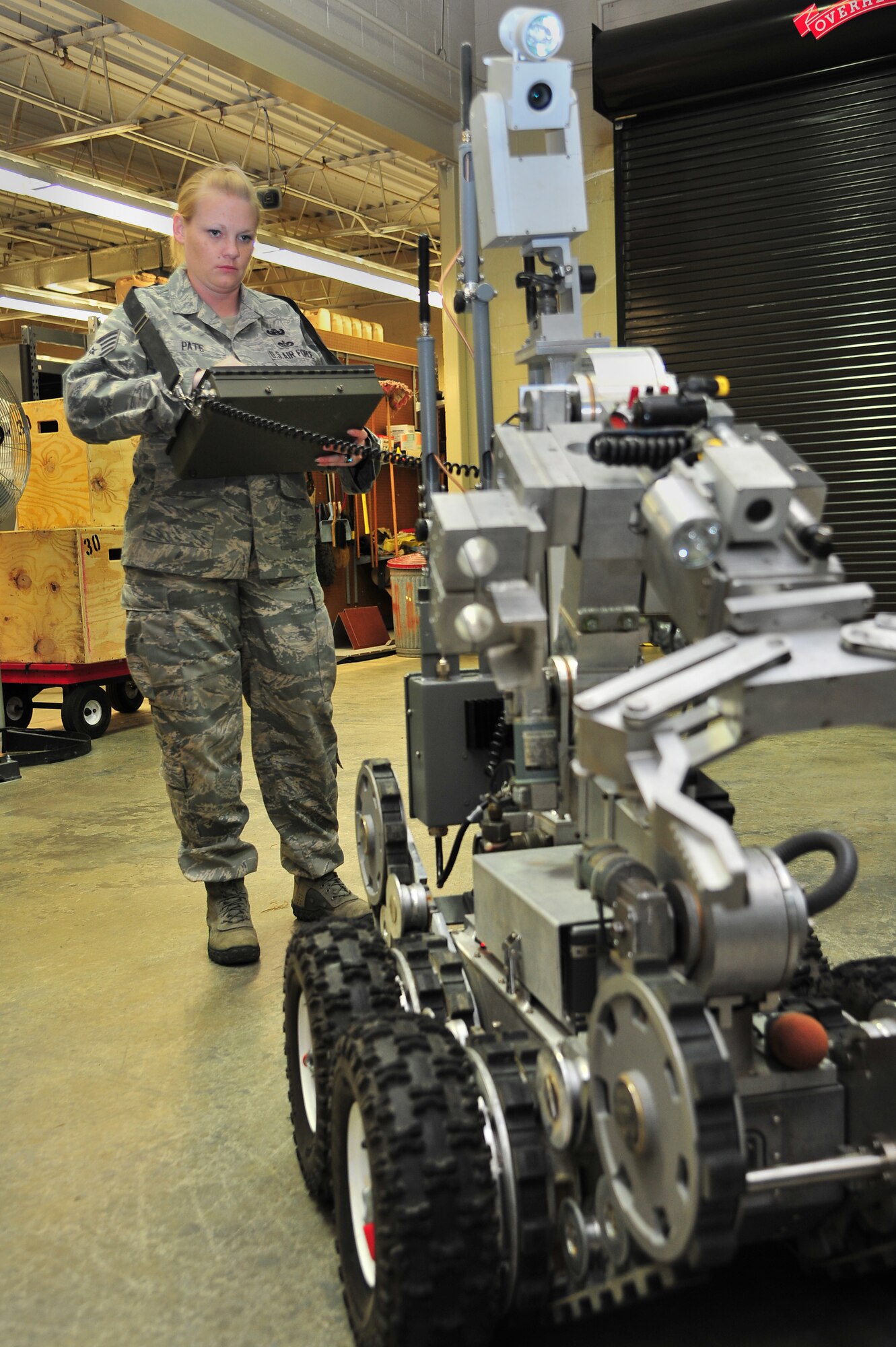 U.S. Air Force Staff Sgt. Kimberly Pate, 4th Civil Engineer Squadron explosive ordnance disposal (EOD) NCO in-charge of operations, maneuvers a robot at Seymour Johnson Air Force Base, N.C., June 13, 2013. EOD teams use robots for reconnaissance and keeping distance between personnel and explosives. Pate was named North Carolina Servicewoman of the Year by the American Legion Auxiliary Past Presidents Parley for her “dedicated support, contribution and commitment to serving in the Armed Forces.” (U.S. Air Force photo by Airman 1st Class Aubrey White/Released)