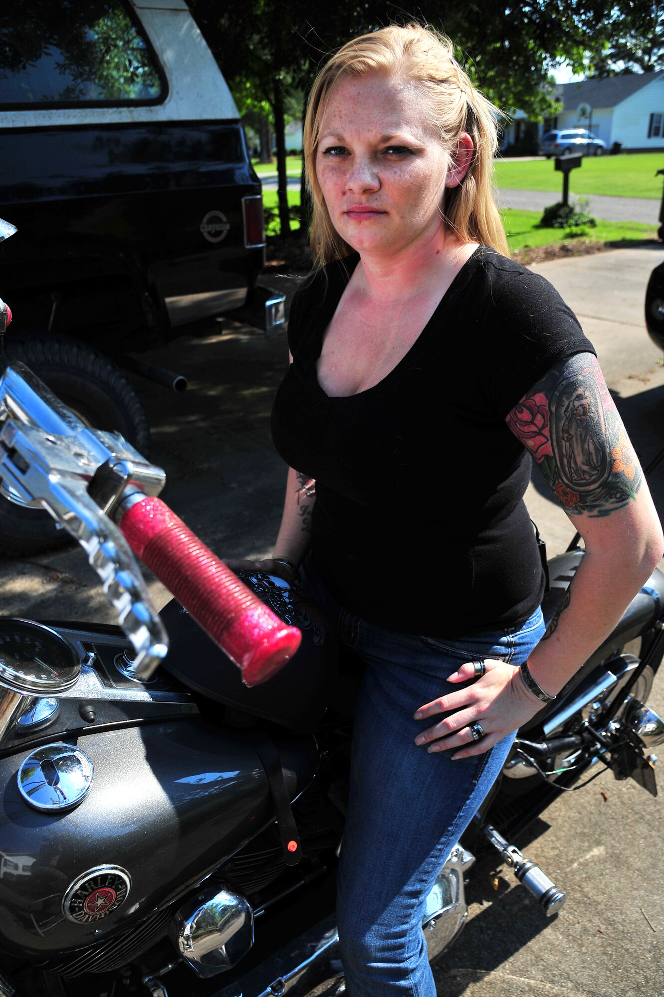 U.S. Air Force Staff Sgt. Kimberly Pate, 4th Civil Engineer Squadron explosive ordnance disposal (EOD) NCO in-charge of operations, sits on her motorcycle outside her home in Kinston, N.C., June 12, 2013. Pate was named North Carolina Servicewoman of the Year by the American Legion Auxiliary Past Presidents Parley for her “dedicated support, contribution and commitment to serving in the Armed Forces.” (U.S. Air Force photo by Airman 1st Class Aubrey White/Released)