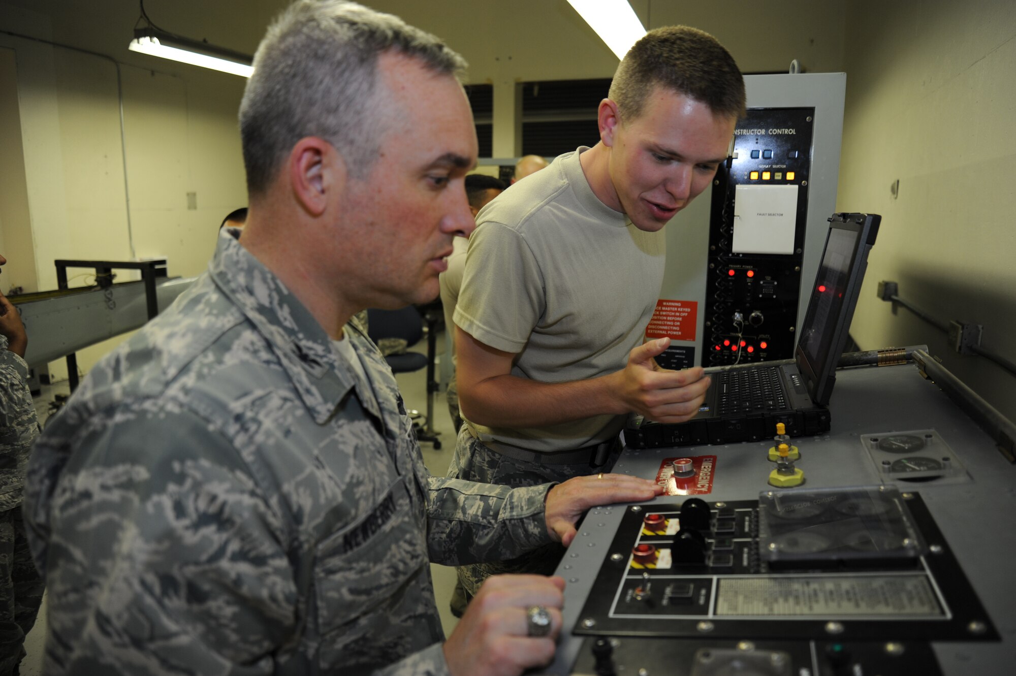 Col. Brian Newberry, 92nd Air Refueling Wing commander and Airman 1st Class Collin Braun, 92nd Aircraft Maintenance Squadron electrical/environmental systems technician, perform a malfunction analysis of the auxiliary power unit starter system at Fairchild Air Force Base, Wash., on June 12, 2013.  APUs are critical in supplying power to aircraft engines. (U.S. Photo by Staff Sgt. Jordan Pollock/Released)  