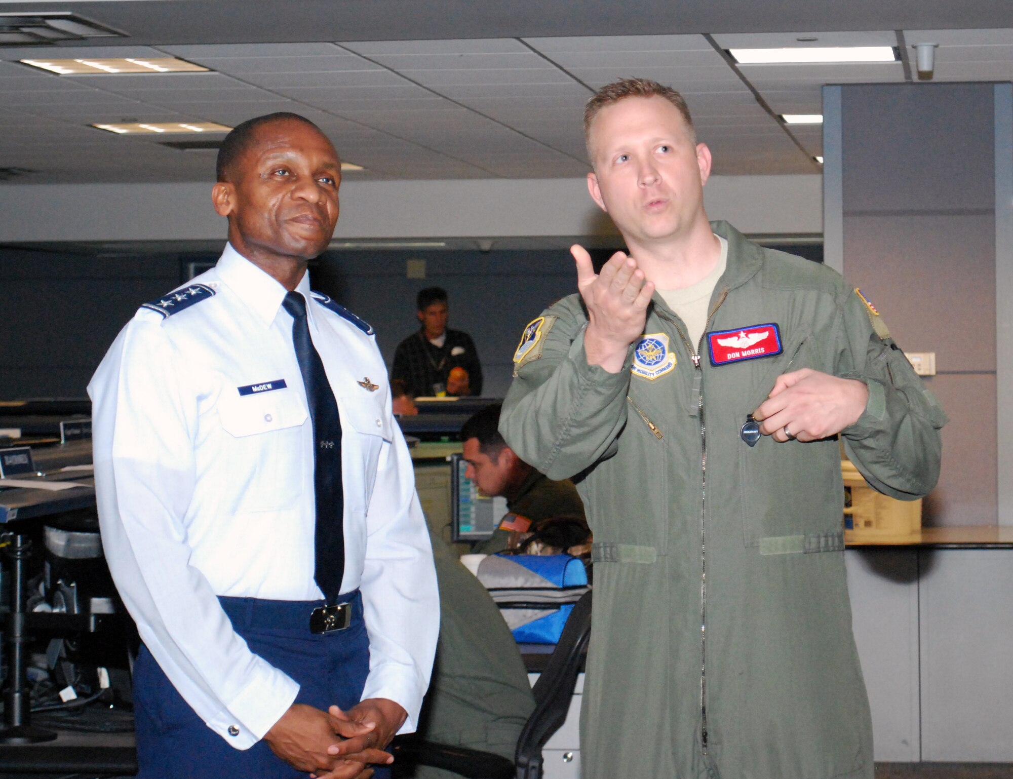 Lt. Gen. Darren McDew, 18th Air Force commander, discusses mission status update with Maj. Don Morris, Deputy Director of Operations, during a visit to the 618 Air and Space Operations Center (Tanker Airlift Control Center) on June 10, 2013. The Director of Operations directorate acts as AMC's single point of contact for AMC mission execution serving as the command's representative to the Joint Staff, Air Force Watch Cell, National Military Command Center, U.S. Transportation Command, other COCOMs, the DOD, and other agencies. (U.S. Air Force photo by 1st Lt. Nicole White)
