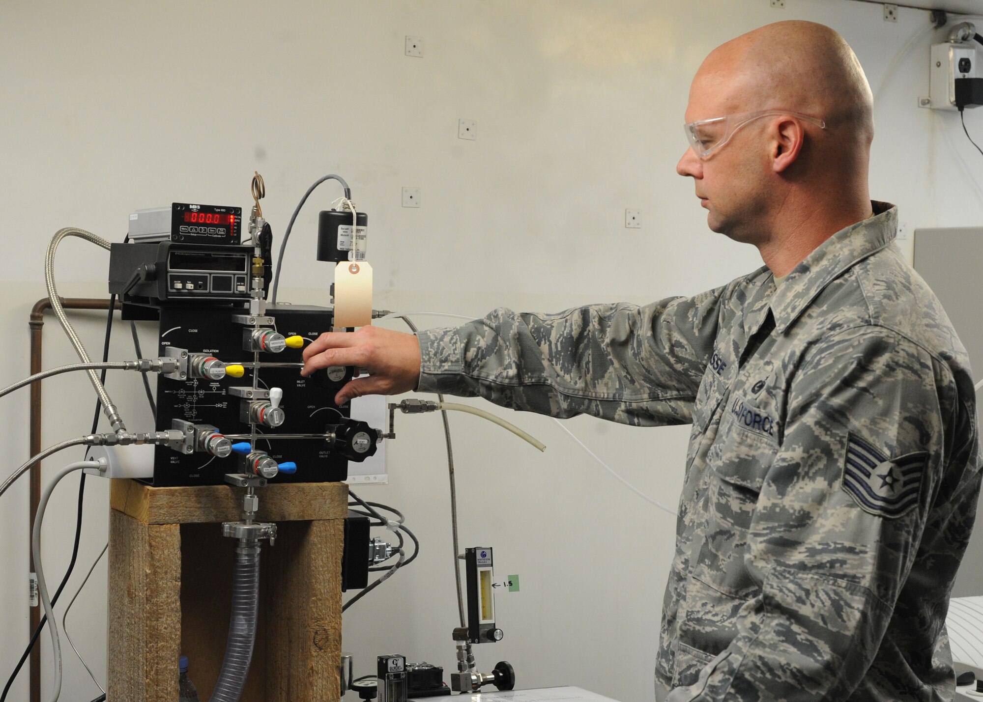 Tech. Sgt. Rocky Sasse uses a device to test gases for purity, odor, moisture and contamination in the 379th Expeditionary Logistics Readiness Squadron Air Force Petroleum Agency Laboratory in Southwest Asia, June 12, 2013. Sasse is the 379th ELRS AFPA NCO in charge of gases deployed from McConnell Air Force Base, Kan. (U.S. Air Force photo/Senior Airman Bahja J. Jones)