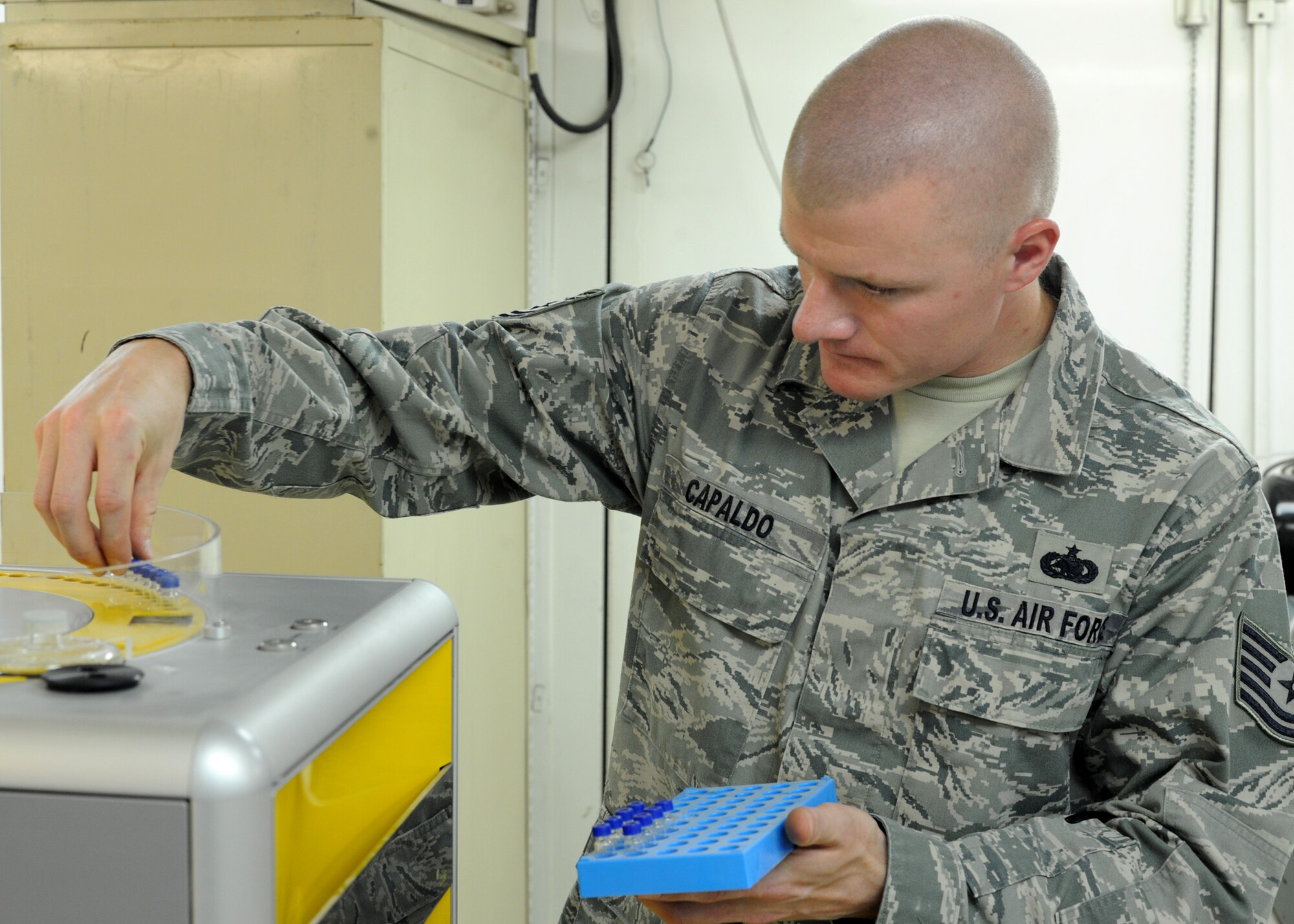 Tech. Sgt. Thomas Capaldo inserts test tubes into a device that conducts a sulfur analysis on fuels in the 379th Expeditionary Logistics Readiness Squadron Air Force Petroleum Laboratory in Southwest Asia, June 12, 2013. This test is one of 15 conducted to ensure the quality of fuels used on aircraft throughout the area of responsibility. Capaldo is the 379th ELRS AFPA NCO in charge of fuels deployed from Dyess Air Force Base, Texas. (U.S. Air Force photo/Senior Airman Bahja J. Jones)