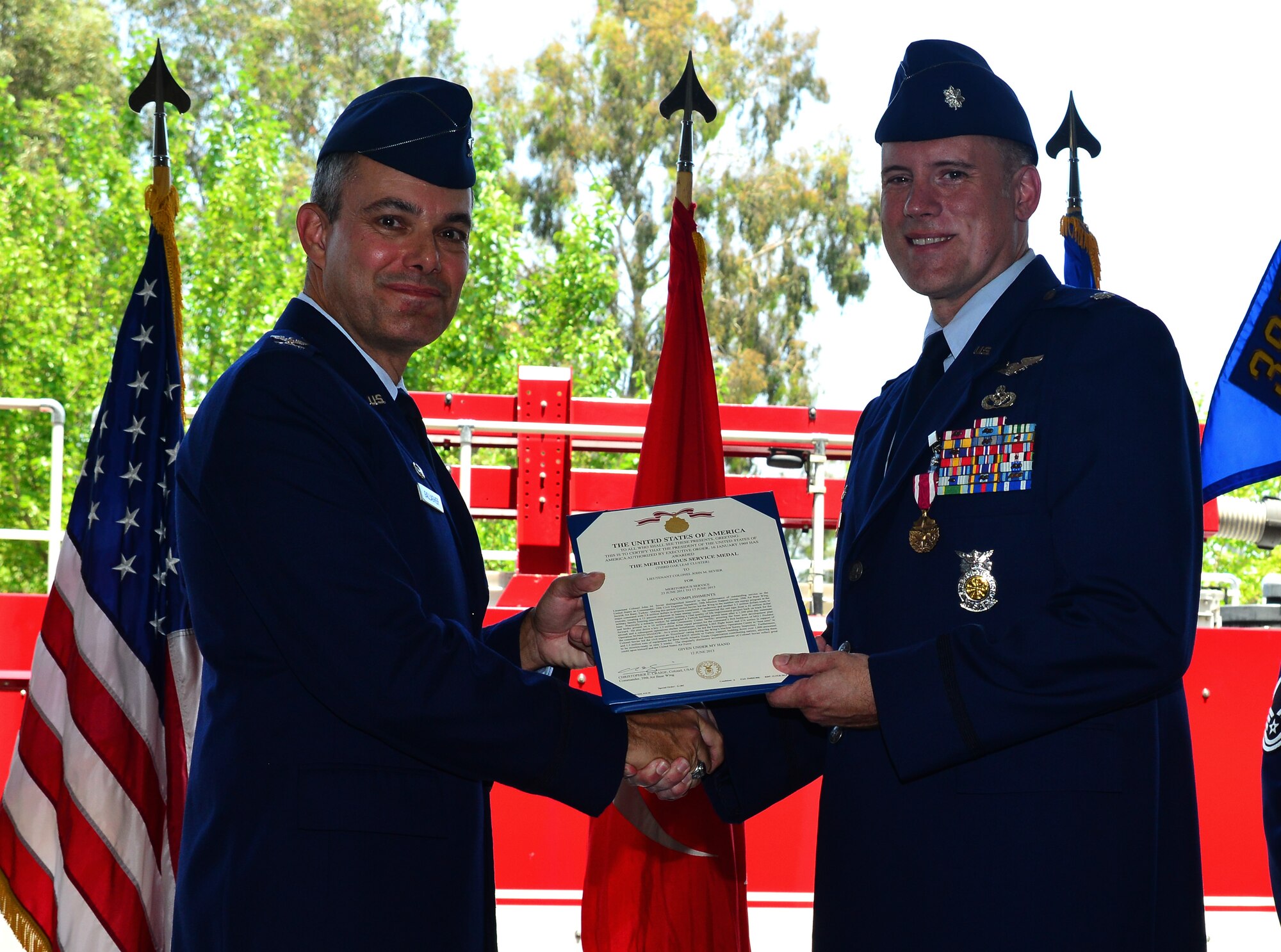 Col. Sean Gallagher, 39th Mission Support Group commander, presents Lt. Col. John Sevier, outgoing 39th Civil Engineer Squadron commander, a Meritorious Service Medal during the 39th CES change of command ceremony June 17, 2013, at Incirlik Air Base, Turkey. Sevier passed command of the 39th CES to Maj. Matthew Welling. (U.S. Air Force photo by Staff Sgt. Eric Summers Jr./Released)