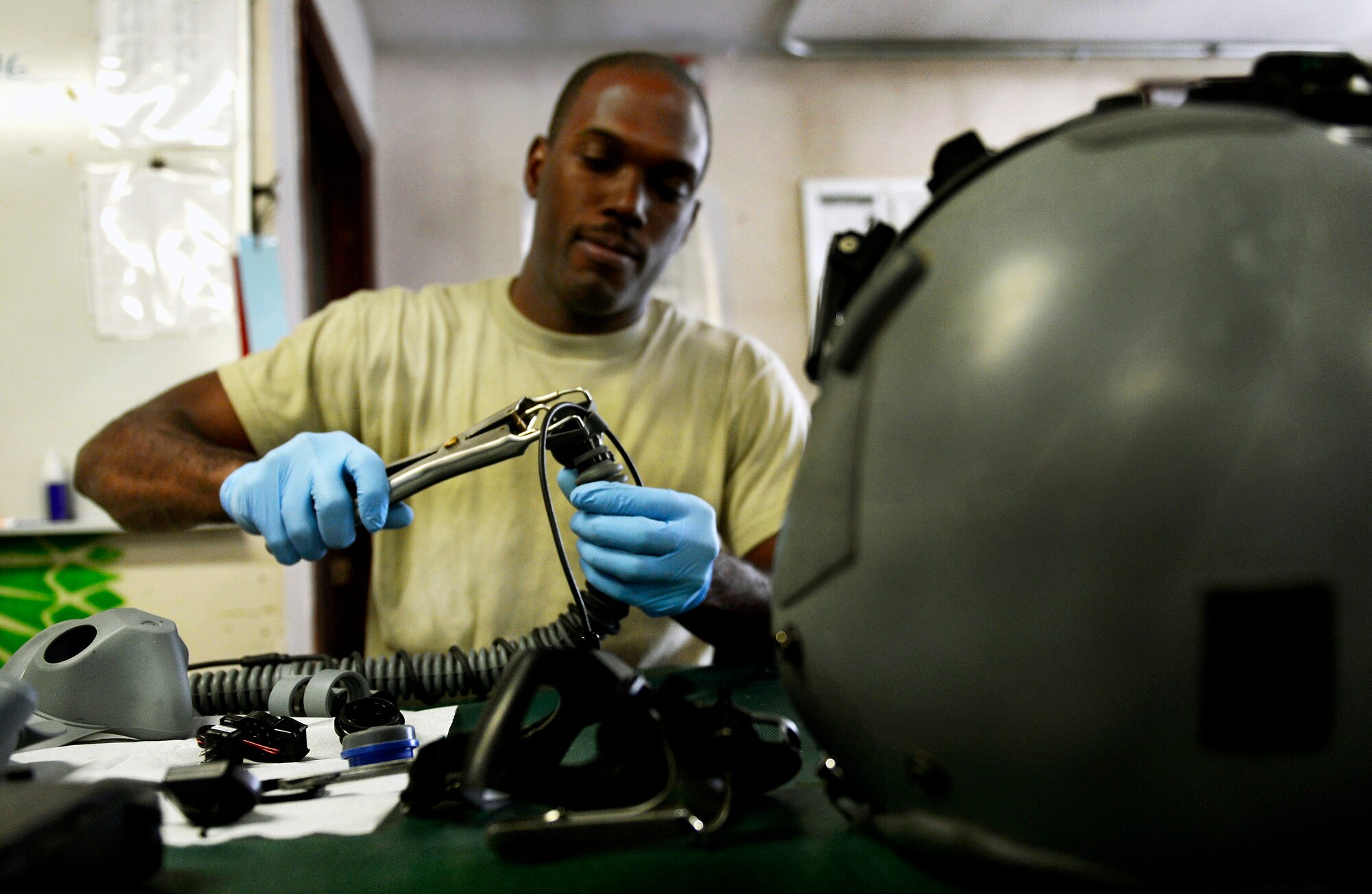 Senior Airman Dieri Dieujuste, 74th Expeditionary Fighter Squadron aircrew flight equipment specialist, checks pilots gear for cracks and tears during a routine 30-day inspection at Bagram Airfield, Afghanistan, June 17. The aircrew flight equipment members have to know many pieces of equipment, including the new Scorpion helmet-mounted cueing system. Dieujuste, native of Fort Pierce, Fla., has supported more than 360 combat sorties and is one of the first Airmen to be qualified on the Scorpion HMCS for A-10 pilots. (U.S. Air Force photo/ Staff Sgt. Stephenie Wade)
