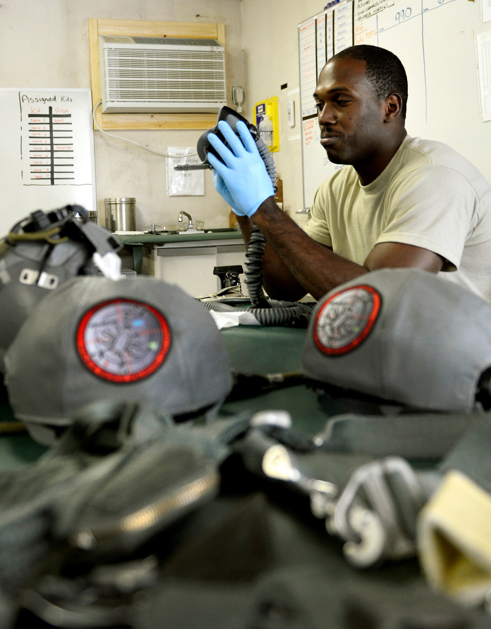 Senior Airman Dieri Dieujuste, 74th Expeditionary Fighter Squadron aircrew flight equipment specialist, checks pilots gear for cracks and tears during a routine 30-day inspection at Bagram Airfield, Afghanistan, June 17. The aircrew flight equipment members have to know many pieces of equipment, including the new Scorpion helmet-mounted cueing system. Dieujuste, native of Fort Pierce, Fla., has supported more than 360 combat sorties and is one of the first Airmen to be qualified on the Scorpion helmet-mounted cueing system for A-10 pilots. (U.S. Air Force photo/ Staff Sgt. Stephenie Wade)