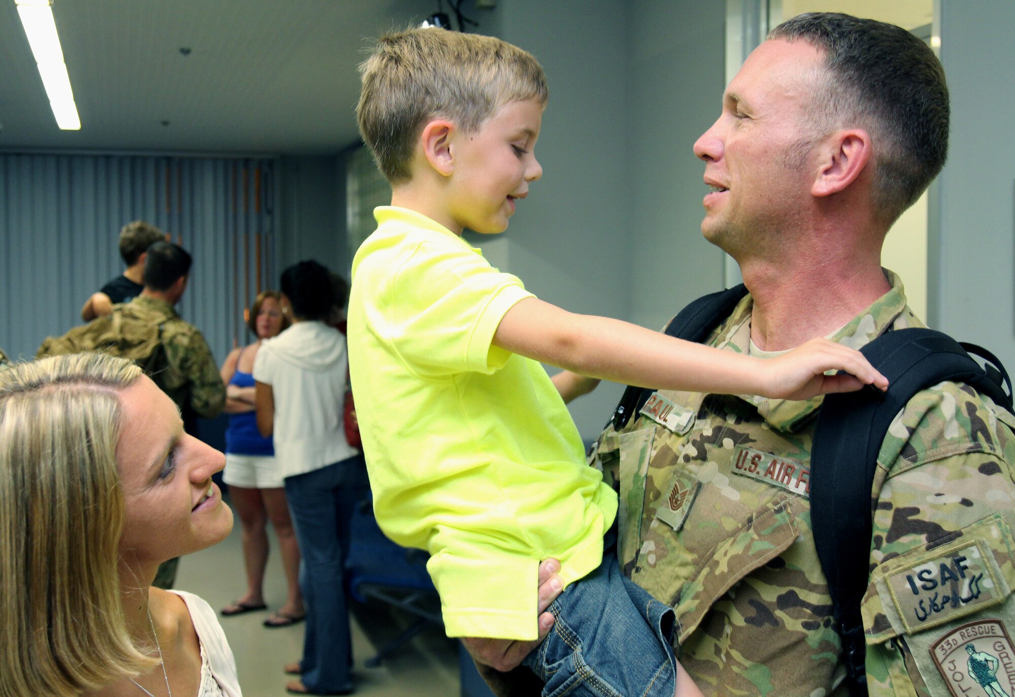 U.S. Air Force Tech. Sgt. Jason Paul, 718th Aircraft Maintenance Squadron expeditor, is welcomed home by his family shortly after returning home to Kadena Air Base, Japan, June 18, 2013. More than 60 Airmen from the 31st and 33rd Rescue Squadrons, 18th Operations Support Squadron, and 718th Aircraft Maintenance Squadron returned home from their deployment to Bagram Airfield, Afghanistan, in support of Operation Enduring Freedom. (U.S. Air Force photo by Tech. Sgt. Jason Lake/Released)