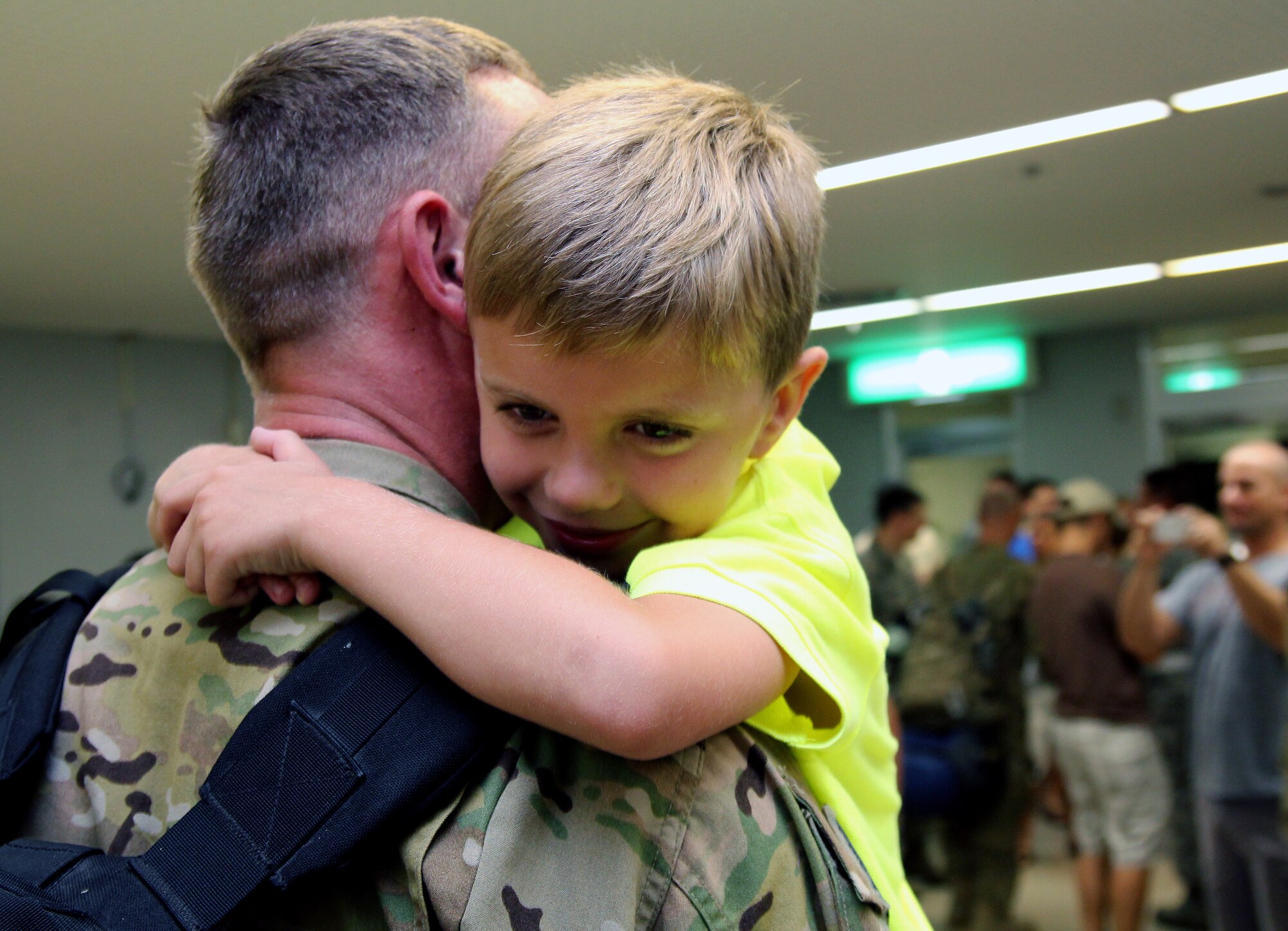 U.S. Air Force Tech. Sgt. Jason Paul, 718th Aircraft Maintenance Squadron expeditor, gets a hug from his son shortly after returning home to Kadena Air Base, Japan, June 18, 2013. More than 60 Airmen from the 31st and 33rd Rescue Squadrons, 18th Operations Support Squadron, and 718th Aircraft Maintenance Squadron returned home from their deployment to Bagram Airfield, Afghanistan, in support of Operation Enduring Freedom. (U.S. Air Force photo by Tech. Sgt. Jason Lake/Released)