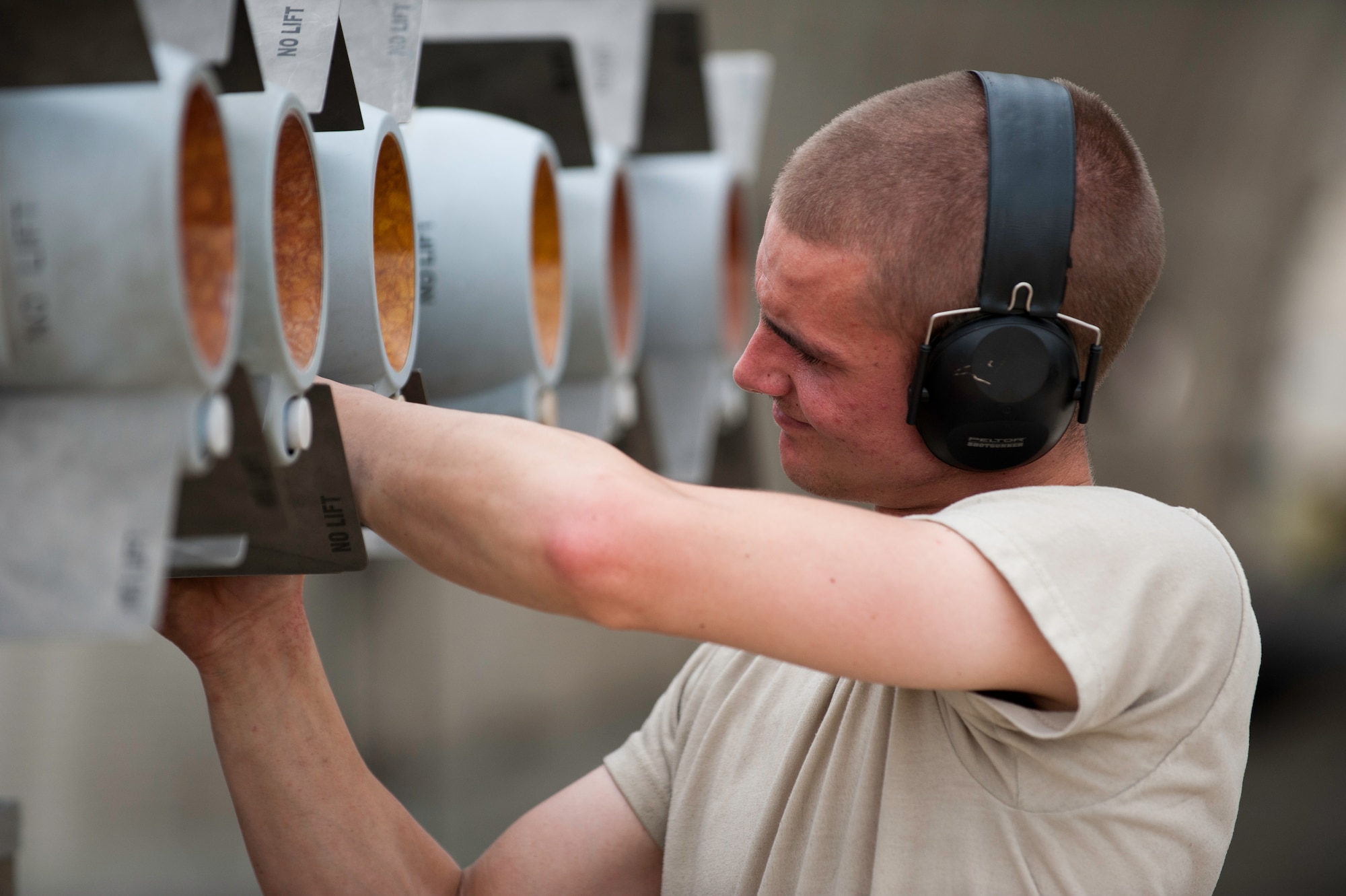 Senior Airman Jerry Boomers, 8th Aircraft Maintenance Squadron weapons load crew member tightens a fin on a missile during a generation exercise at Kunsan Air Base, Republic of Korea, June 17, 2013. Airmen must be ready to ‘defend the base,’ ‘accept follow on forces’ and ‘take the fight north’ at any time. (U.S. Air Force photo by Senior Airman Armando A. Schwier-Morales)