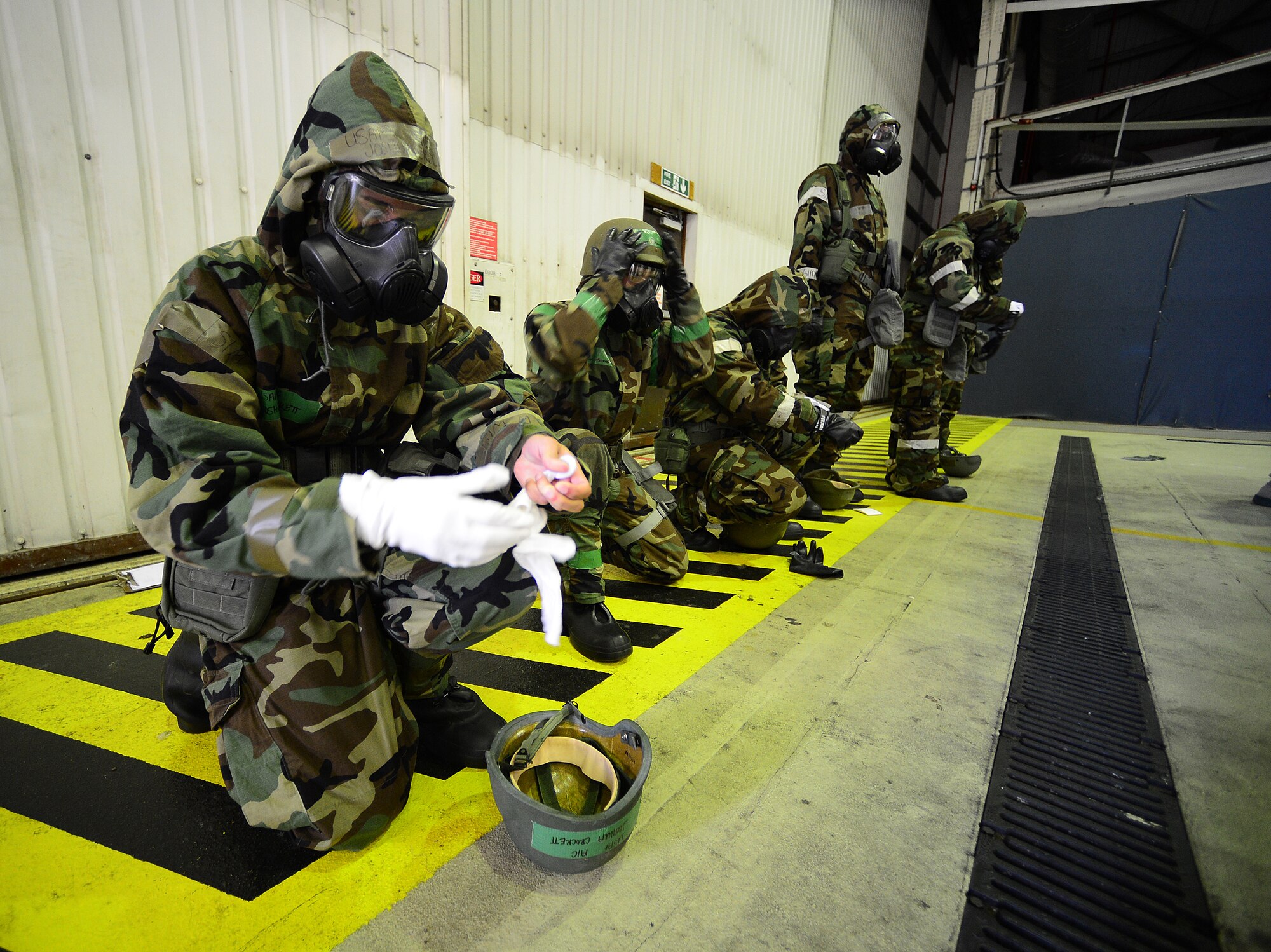 ROYAL AIR FORCE LAKENHEATH, England – Liberty Airmen don protective gear and gas masks for a simulated MOPP 4 in Hangar 7 June 17, 2013. ATSO training provided Airmen readiness training in preparation for the Phase II exercise. (U.S. Air Force photo by Senior Airman Tiffany M. Grigg)