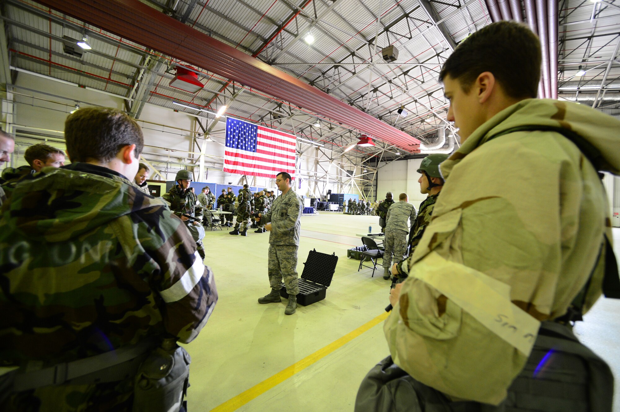 ROYAL AIR FORCE LAKENHEATH, England – Staff Sgt. Keith Ulrich, 48th Security Forces Squadron NCO in charge of Armory (center), instructs a group of officers on how to clear an M-9 during the Ability to Survive and Operate Rodeo in Hangar 7 June 17, 2013. ATSO training provided Airmen readiness training in preparation for the Phase II exercise. (U.S. Air Force photo by Senior Airman Tiffany M. Grigg) 