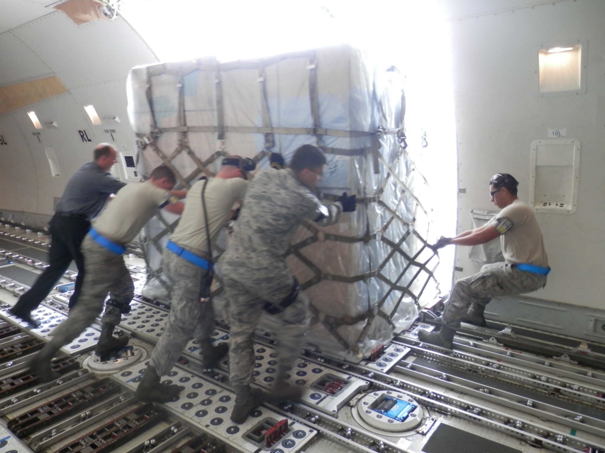 731st Air Mobility Squadron members push a cargo pallet onto a tunner at Kunsan Air Base, Republic of Korea. The 731st AMS ultimately handled 22 cargo aircraft and proved Osan’s capability to operate from any location on the Korean peninsula after transitioning to Kunsan for a projected two-month partial runway closure. (Air Force courtesy photo/Master Sgt. David Hardy)