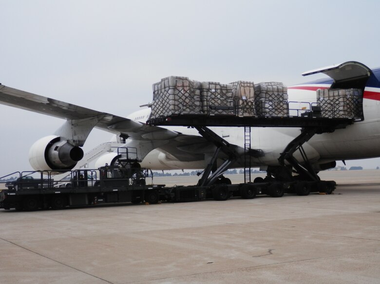 Palletized household goods are downloaded onto the tunner at Kunsan Air Base, Republic of Korea. The 731st AMS ultimately handled 22 cargo aircraft and proved Osan’s capability to operate from any location on the Korean peninsula after transitioning to Kunsan for a projected two-month partial runway closure. (Air Force courtesy photo/Master Sgt. David Hardy)