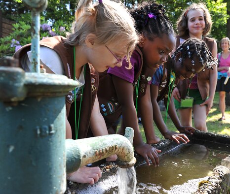 USA Girl Scouts Overseas play in the water during their field trip to the water treatment facility, June 13, 2013, Ramstein Air Base, Germany. The 786th Civil Engineer Squadron tests and purifies the drinking water for the KMC to ensure the distributed water is consumable for Airmen and civilians on base. (U.S. Air Force photo/Airman 1st Class Dymekre Allen)