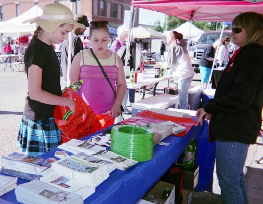 ROCKY FORD, COLO., -- Debby Schibbelhut(R) looks on as two children stop by the Corps' water safety booth at the 9th Annual Cruisin’ Into Summer and Keep Kids Safe Fair June 1, 2013. More than 550 children and adults stopped by the booth.