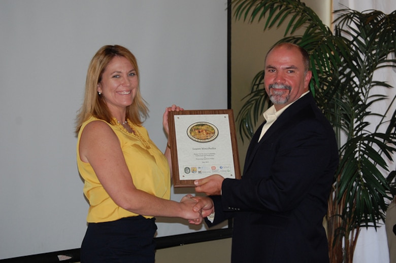 Susan Waichulis (left), project manager with the Fort Myers regulatory section, was recognized by Larry Williams, U.S. Fish and Wildlife Service, for her role in performing the jurisdictional determination needed to move the project forward. 