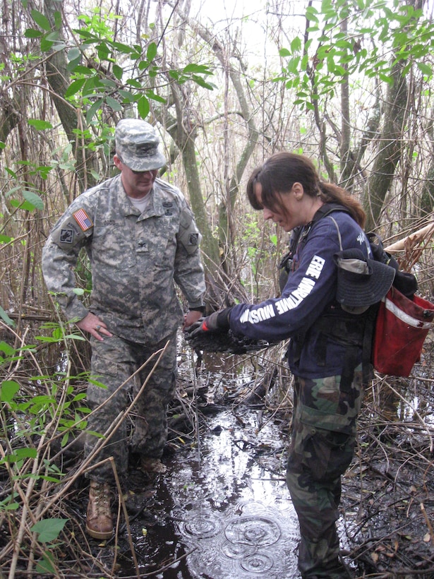 Archaeologist Cynthia Thomas (right), instructs Col. Alan Dodd (left), district commander on archaeological field techniques. 