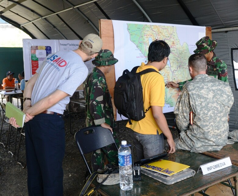 MAJ Andrew Staiano (USARPAC) and Mr. Dan Dieckhaus (USAID-OFDA) discuss an engineering assessment requirement during the 2013 Indonesia Pacific Resilience Disaster Response Exercise & Exchange.