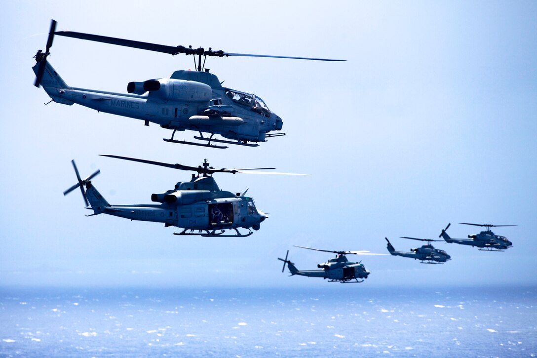 AH-1W Super Cobra and UH-1Y Huey helicopters fly in formation during maintenance and readiness flights near the coast of Lanai, Hawaii, June 13, 2013.