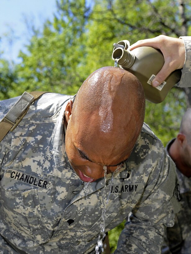 Army Spc. Wyatt Chandler receives a stream of water to relieve the effects of a gas after exiting the Arctic Nuclear, Biological and Chemical Chamber on Joint Base Elmendorf-Richardson, Alaska, June 17, 2013. Chandler is assigned to Company C, 3rd Battalion, Airborne, 509th Infantry Regiment.