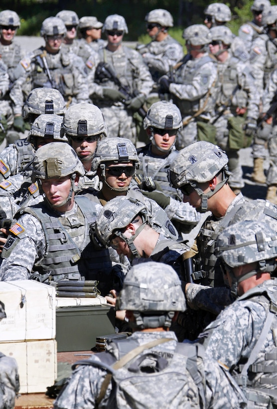 Soldiers draw ammunition before weapons qualifying during nuclear, biological and chemical training at the Small Arms Complex on Joint Base Elmendorf-Richardson, Alaska, June 17, 2013. The soldiers are assigned to Company B, 3rd Battalion, Airborne, 509th Infantry Regiment.
