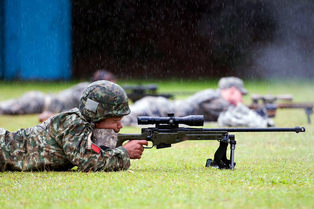 U.S. and Indonesian army paratroopers fire sniper rifles during exercise Garuda Shield 2013 at 1st Kostrad headquarters in West Java, Indonesia, June 10, 2013.