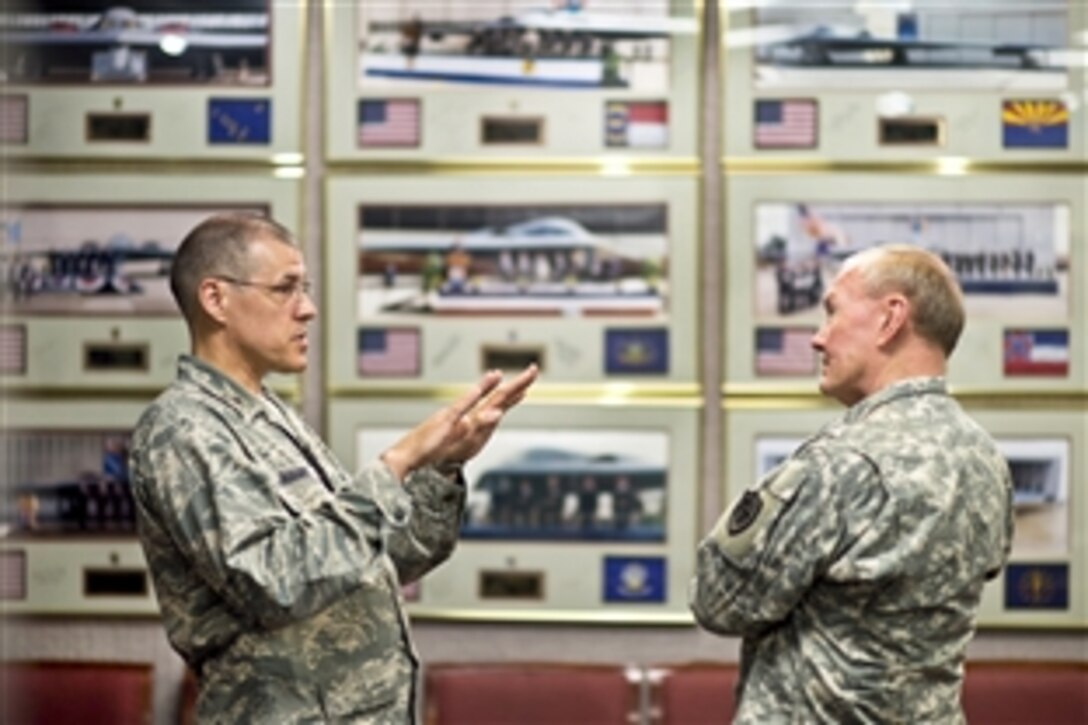 Air Force Brig. Gen. Thomas A. Bussiere, left, commander of the 509th Bomb Wing, briefs Army Gen. Martin E. Dempsey, chairman of the Joint Chiefs of Staff, about B-2 bomber operations and maintenance on Whiteman Air Force Base, Mo., June 18, 2013. 