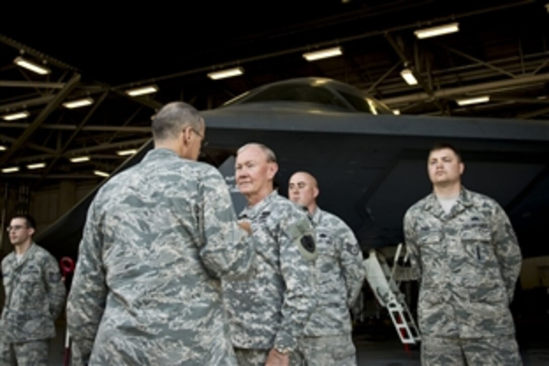 Air Force Brig. Gen. Thomas A. Bussiere, commander of the 509th Bomb Wing, briefs Army Gen. Martin E. Dempsey, chairman of the Joint Chiefs of Staff, about B-2 bomber operations and maintenance on Whiteman Air Force Base, Mo., June 18, 2013. 