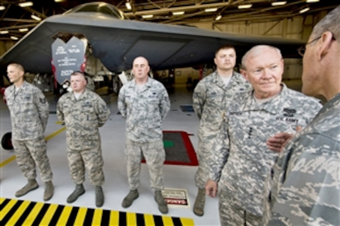 Air Force Brig. Gen. Thomas A. Bussiere, far right, commander of the 509th Bomb Wing, briefs Army Gen. Martin E. Dempsey, chairman of the Joint Chiefs of Staff, about B-2 bomber operations and maintenance on Whiteman Air Force Base, Mo., June 18, 2013.    