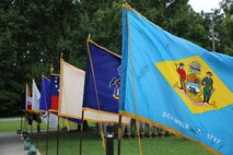 State flags are posted during a change of charge ceremony aboard Camp Lejeune, N.C., June 18, 2013. Master Chief Petty Officer Christopher L. Hill was relieved of his post, and Master Chief Petty Officer Michael J. Roberts assumed the post along with a Navy cutlass, symbolizing the passing of responsibility of the enlisted personnel of the battalion. (U.S. Marine Corps photo by Lance Cpl. Shawn Valosin)