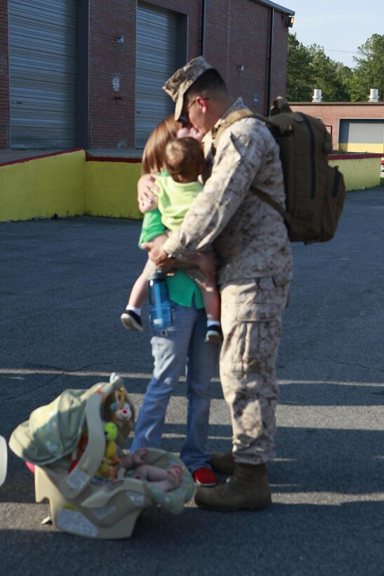 Sgt. Mark Gonzales, a data network specialist with Marine Air Control Squadron 2, embraces his family before departing for Afghanistan.