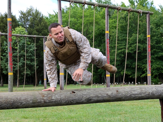 Maj. James Pelland, team lead for Marine Corps Systems Command’s Individual Armor Team, jumps over a log to demonstrate the mobility provided by a prototype Modular Scalable Vest, the next generation body armor for the Marine Corps. The MSV will combine attributes from the two most recently fielded protective vests and is being developed by the armor team.