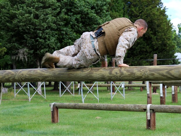 Maj. James Pelland, team lead for Marine Corps Systems Command’s Individual Armor Team, jumps over a log to show the demonstrate the mobility provided by a prototype Modular Scalable Vest, the next generation body armor for the Marine Corps. A concept being considered for the MSV is the addition of a central load management and distribution system (shown here) that is modeled after the human spine to help distribute the weight Marines carry from their shoulders to their hips. The MSV will combine attributes from the two most recently fielded protective vests and is being developed by the armor team. 