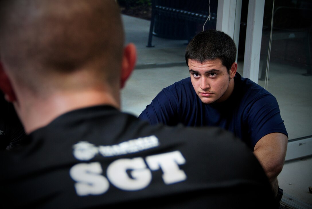 Marine Corps recruiter Sgt. Matthew Jacobs, Recruiting Substation Naples, Recruiting Station Fort Lauderdale, Fla., talks with a group of future Marines about small unit leadership after their evening workout June 12, 2013. Recruiters train and mentor dozens of future Marines each week and demand a high standard of mental, moral and physical strength