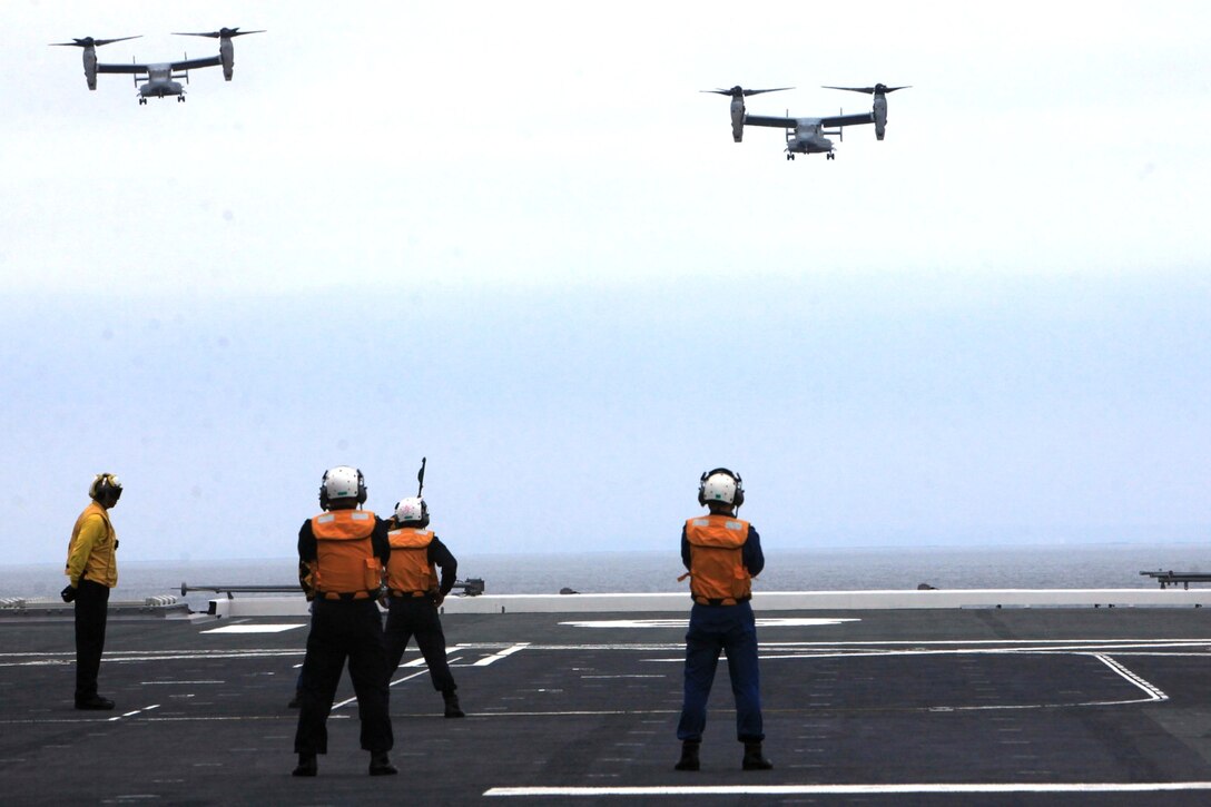 Two MV-22B Ospreys from Marine Medium Tiltrotor Squadron 161 (VMM-161) prepare to land onboard the JS Hyuga (DDG-181), during Dawn Blitz 2013 off the coast of Naval Base Coronado, June 14. Exercise Dawn Blitz 2013 is a multinational amphibious exercise off the Southern California coast that refocuses Navy, Marine Corps and coalition forces in their ability to conduct complex amphibious operations essential for global crisis response across the range of military operations.