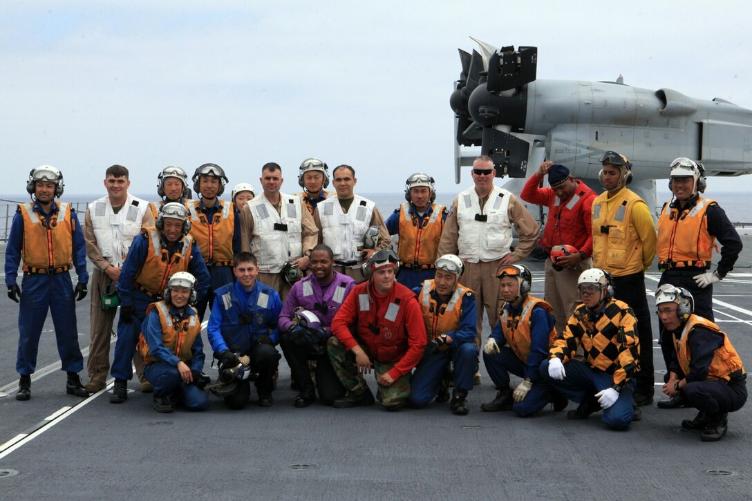 Marines, U.S. Navy sailors and sailors with the Japanese Maritime Defense Forces gather for a group photo after successfully landing an MV-22B Osprey from Marine Medium Tiltrotor Squadron 161 (VMM-161) onboard the JS Hyuga (DDG-181), during Dawn Blitz 2013 off the coast of Naval Base Coronado, June 14. Exercise Dawn Blitz 2013 is a multinational amphibious exercise off the Southern California coast that refocuses Navy, Marine Corps and coalition forces in their ability to conduct complex amphibious operations essential for global crisis response across the range of military operations.