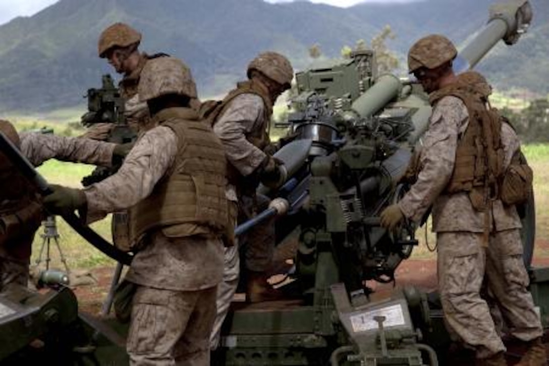 Marines with Bravo Battery, 1st Battalion, 12th Marine Regiment, load a round into a M777 Howitzer, May 14, 2013, at Schofield Barracks in Wahiawa during a training exercise. The howitzer uses a computer system for digital communications over the traditional voice communications.


