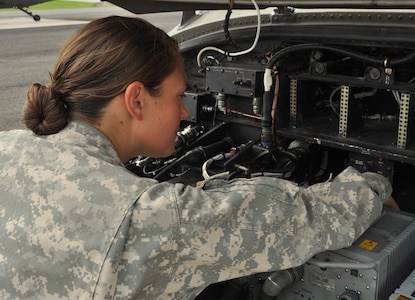 U.S. Army 1st Lt. Martha Hugo, a 1-228 Aviation Regiment Alpha Company pilot, checks the avionic department of the Utility Helicopter-60 Blackhawk, at Soto Cano Air Base, Honduras, for loose wires and to ensure the security of the electronics June 17, 2013 before flying the aircraft. The 1-228 ARAC provided their junior pilots with a mission scenario and had them create a mission plan from start to finish and then perform the task.