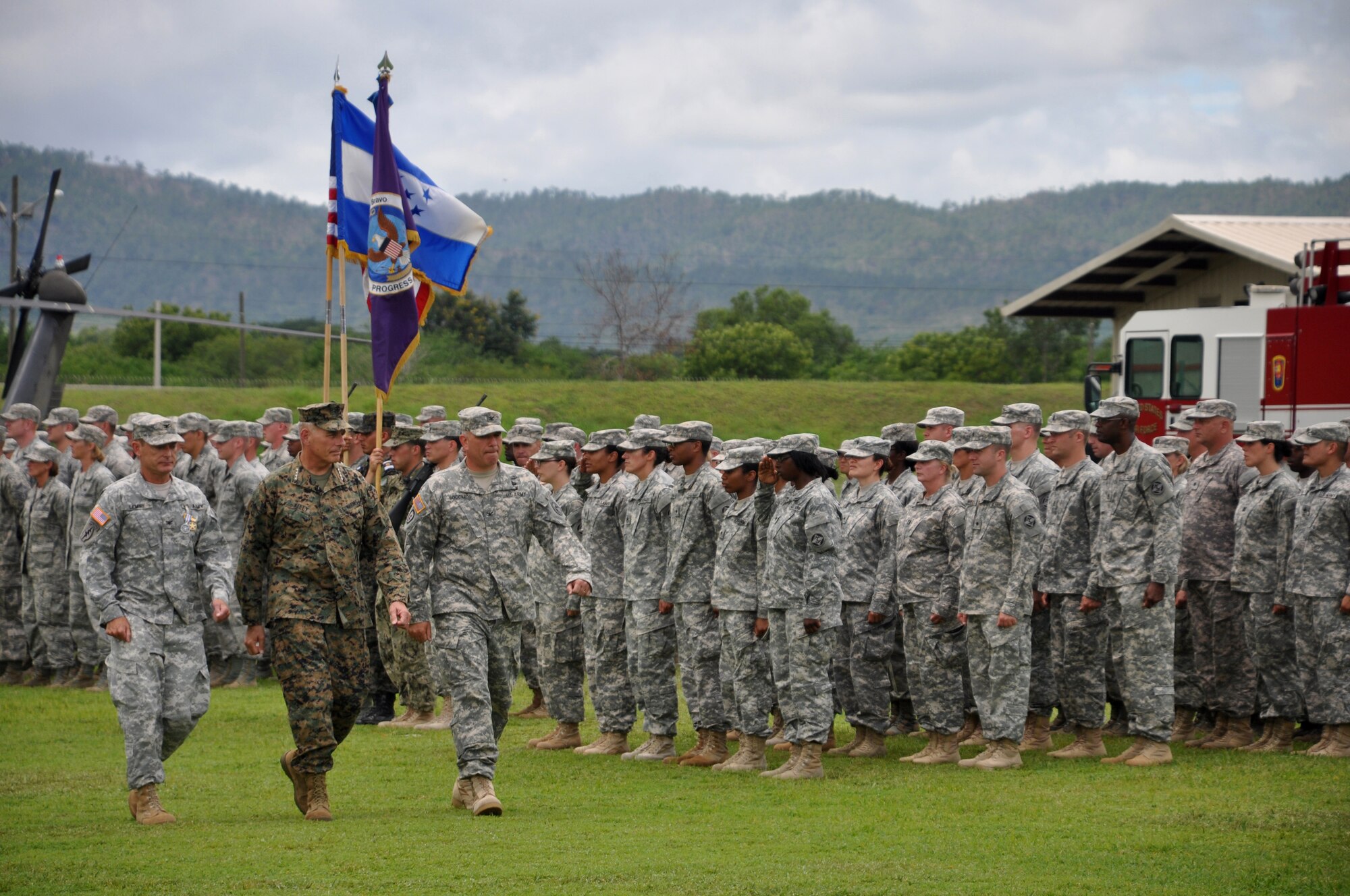 Army Col. Guy A. LeMire(left), Marine Gen. John F. Kelly (center) and Army Col. Thomas D. Boccardi(right) inspect soldiers in formation during the change of command ceremony at Soto Cano Air Base, Honduras, June 20, 2013. The ceremony was held for the out-going  JTF-Bravo  Commander Col. LeMire and the incoming JTF-Bravo Commander Col. Boccardi.