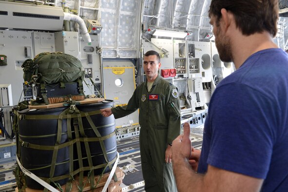 Capt. Kyle Clinton, 62nd Airlift Wing weapons and tactics director, briefs Forrest Griffin, former UFC heavy lightweight champion and member of AmericanDreamU, on the airdrop capabilities of a C-17 Globemaster III aircraft during a tour June 20, 2013 at Joint Base Lewis-McChord, Wash. AmericanDreamU is a program for servicemembers that helps them find their dream job or build their own business. (U.S. Air Force photo/Airman 1st Class Jacob Jimenez)