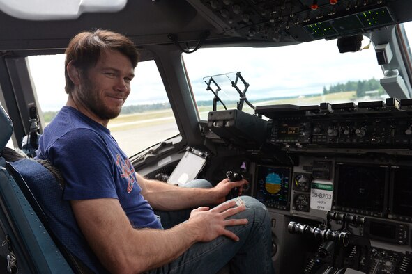 Forrest Griffin, former UFC heavy lightweight champion and member of AmericanDreamU, enjoys the view from the pilot’s seat of a C-17 Globemaster III aircraft during a tour June 20, 2013 at Joint Base Lewis-McChord, Wash. Griffin will be a guest speaker for an event scheduled for June 21 where he and other individuals will discuss a variety of topics related to finding a business idea and making the first steps toward running a business. (U.S. Air Force photo/Airman 1st Class Jacob Jimenez)