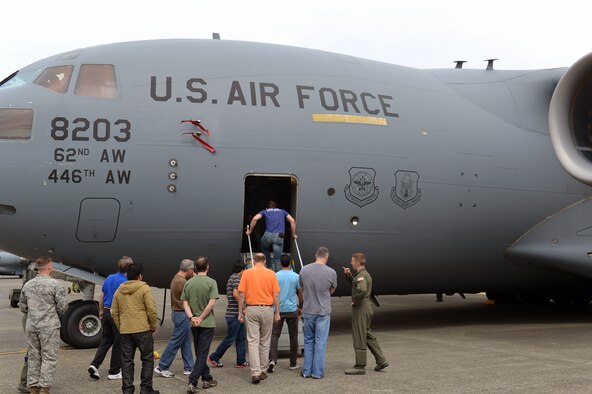 Members of AmericanDreamU board a C-17 Globemaster III aircraft during a tour June 20, 2013 at Joint Base Lewis-McChord, Wash. AmericanDreamU is hosting an event scheduled for June 21 where a speaker panel will discuss a variety of topics related to finding a business idea and making the first steps toward running a business. (U.S. Air Force photo/Airman 1st Class Jacob Jimenez)