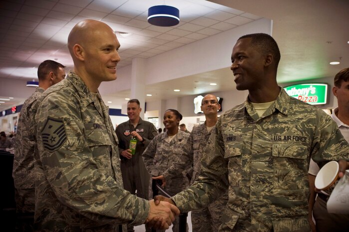 Senior Airman Devin Jones, 99th Logistics Readiness Squadron computer technician, thanks Master Sgt. Adam Carroll, 99th Medical Support Squadron first sergeant, for paying for his meal at Taco Bell during an Operation Warmheart event June 19, 2013, at Nellis Air Force Base, Nev. Operation Warmheart performs random acts of kindness for the purpose of health, welfare, and morale events for the Airmen in the Nellis and Creech AFBs communities. (U.S. Air Force photo by Airman 1st Class Christopher Tam)