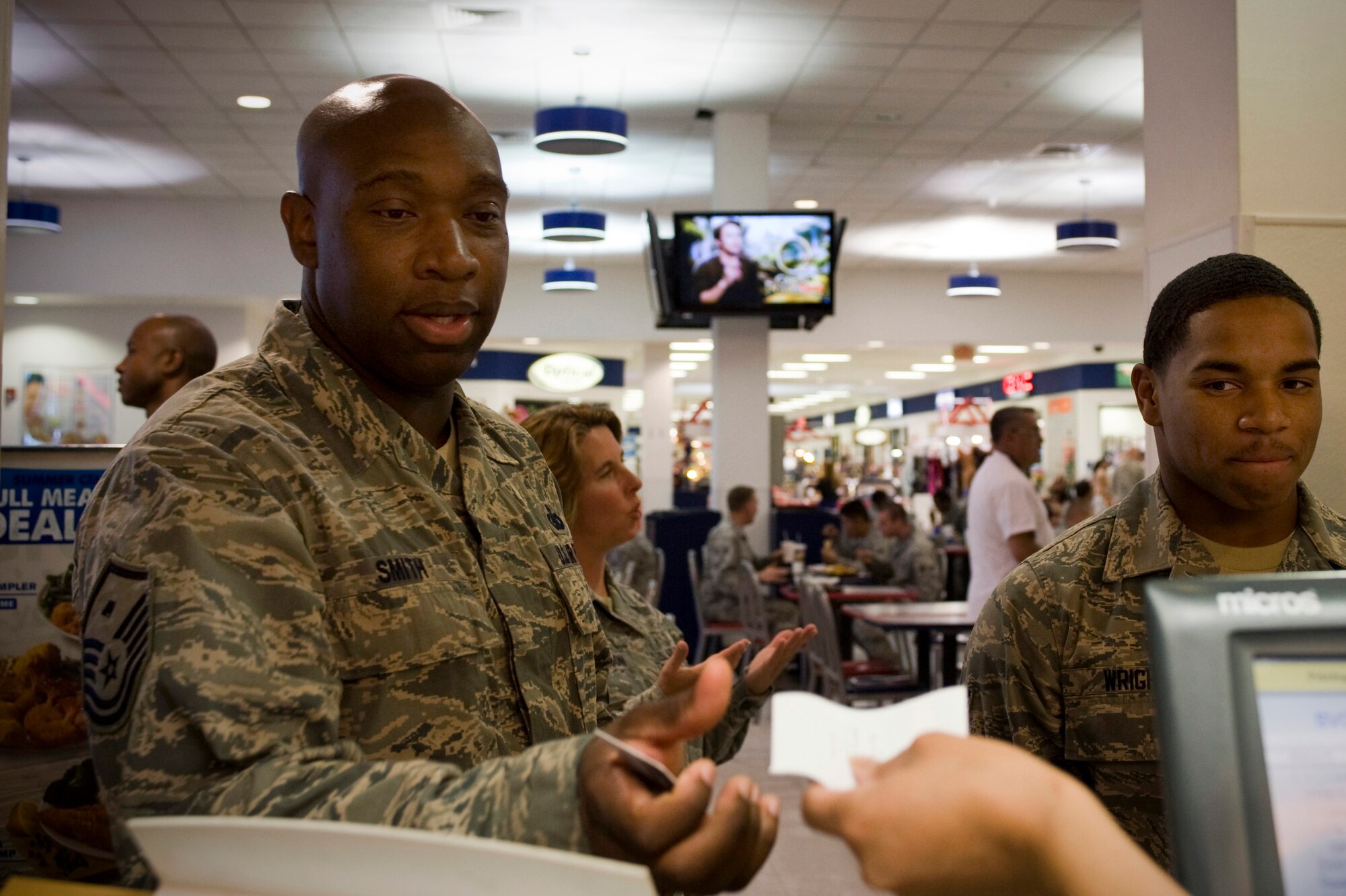 Master Sgt. Anthony Smith, 99th Force Support Squadron first sergeant, buys lunch for Airman 1st Class Harold Wright, 99th Aerospace Medicine Squadron public health technician, at Captain D's Seafood during an Operation Warmheart event June 19, 2013, at Nellis Air Force Base, Nev. Operation Warmheart is maintained by Air Force first sergeants and all donations directly support the fund. (U.S. Air Force photo by Airman 1st Class Christopher Tam)