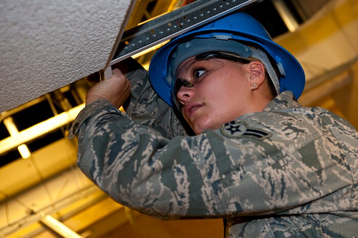 Airman 1st Class Brianna Harrison, 99th Civil Engineer Squadron structural specialist, removes a ceiling grid June 19, 2013, at the 99th CES Explosive Ordinance Flight building at Nellis Air Force Base, Nev. Harrison was selected as the Diamond Sharp Award recipient for June by members of the Nellis First Sergeants’ Association. The award is designed to recognize Airmen who truly stand out due to their abilities, sheer drive and leadership characteristics. Harrison helped to construct a 100-foot ventilation system for the 820th RED HORSE Dining Facility, saving the Air Force $25,000 in repair costs. Additionally, she was elected public relations officer for the Airmen Committed to Excellence organization, in which she will publicize and help execute events affecting the morale of more than 2,600 Airmen from Nellis and Creech AFBs. She has also finished college credits for her Community College of the Air Force degree. (U.S. Air Force photo by Staff Sgt. Michael Charles)