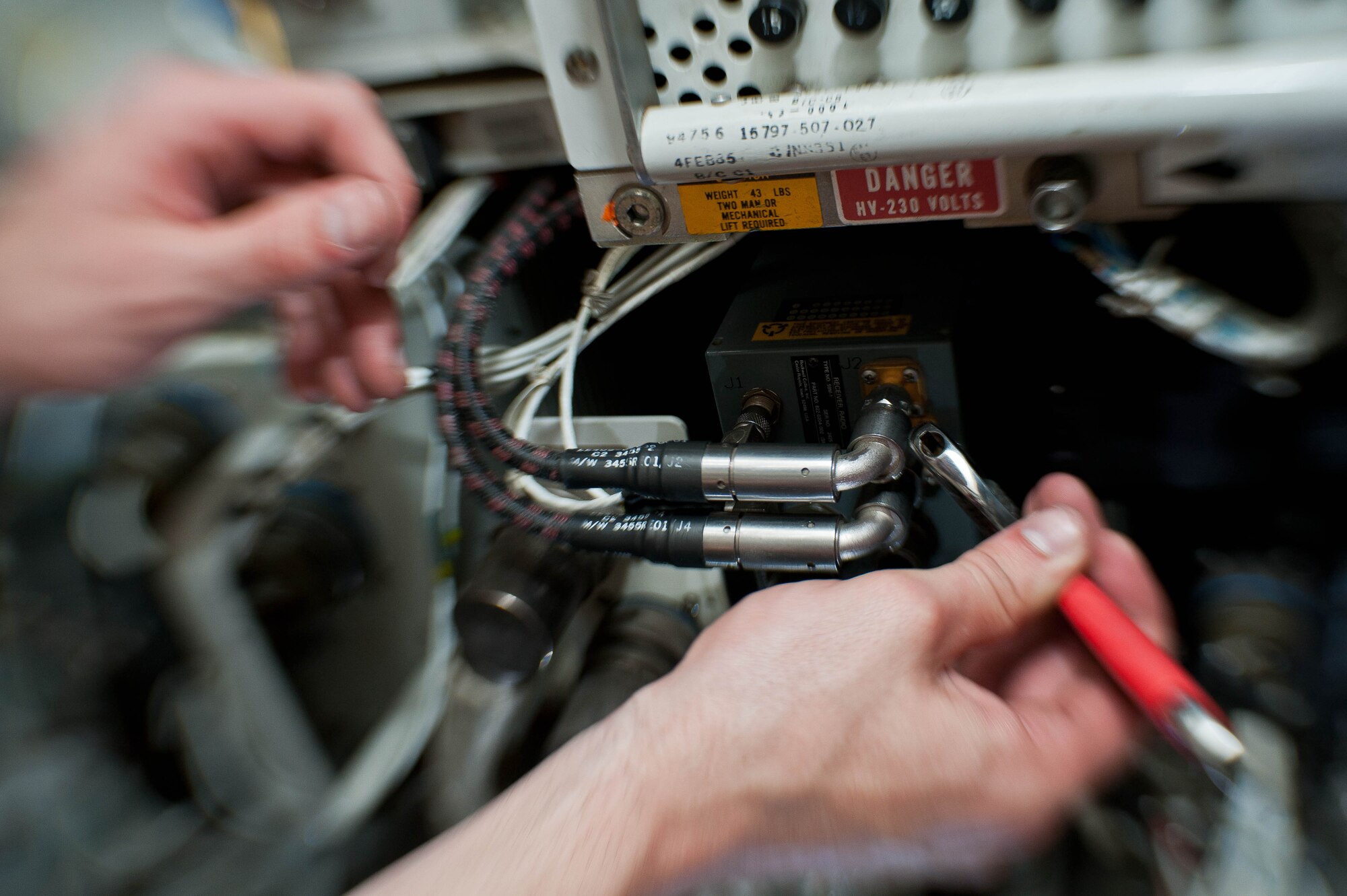 Airman 1st Class Jeffrey Merrill, 28th Aircraft Maintenance Squadron offensive avionic systems specialist, connects a power control assembly battery into the electrical multiplex system in a B-1 bomber during routine maintenance at Ellsworth Air Force Base, S.D., June 18, 2013. The electrical multiplex system is responsible for powering the radar, GPS, sniper pod, navigation and communications systems in the B-1. (U.S. Air Force photo by Airman 1st Class Zachary Hada/Released)