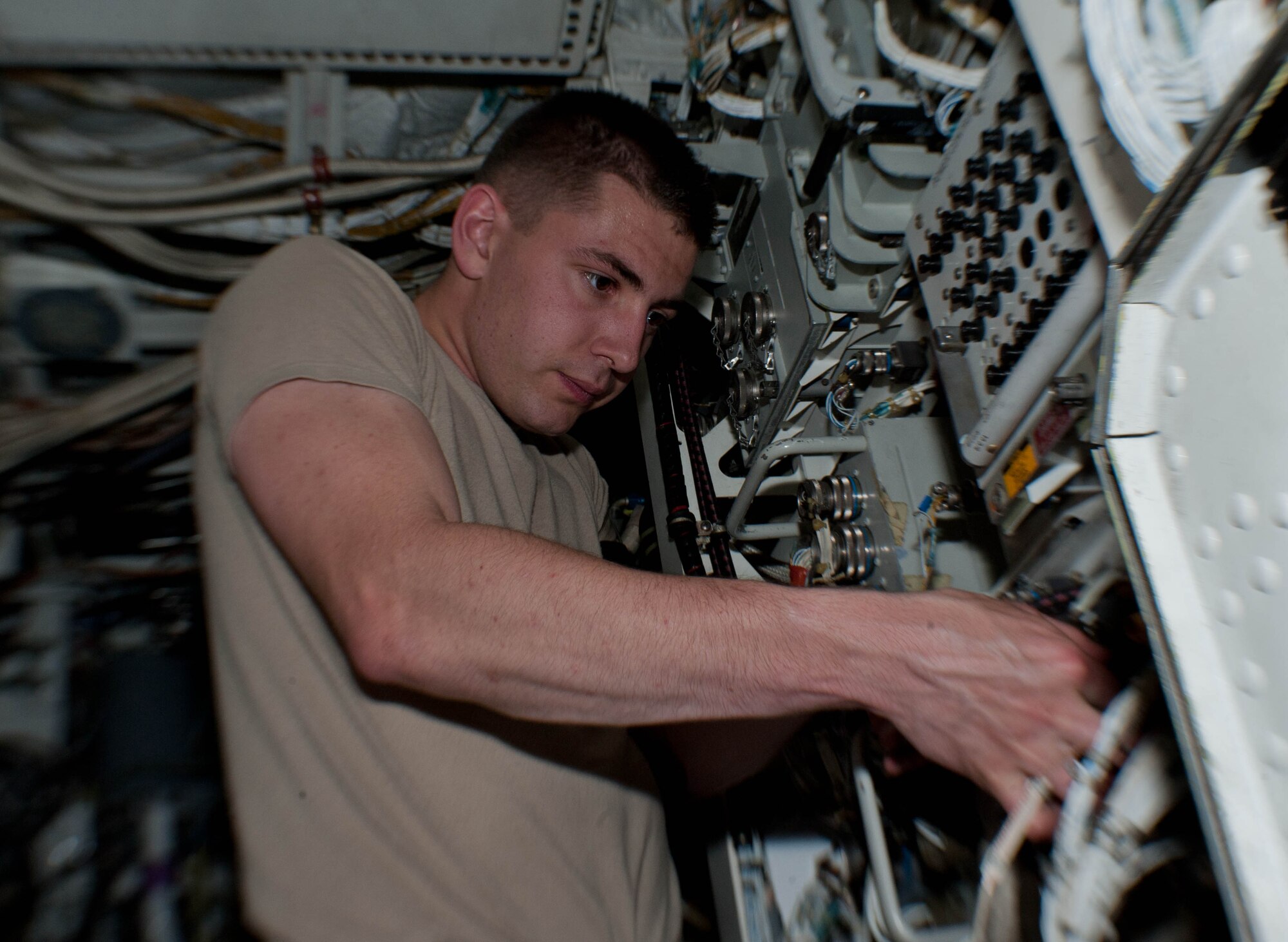 Airman 1st Class Jeffrey Merrill, 28th Aircraft Maintenance Squadron offensive avionic systems specialist, inspects a power control assembly battery for the central integrated test systems in a B-1 bomber during routine maintenance at Ellsworth Air Force Base, S.D., June 18, 2013. The system powers the B-1’s GPS, navigation, communication, sniper pod and radar capabilities.(U.S. Air Force photo by Airman 1st Class Zachary Hada/Released)