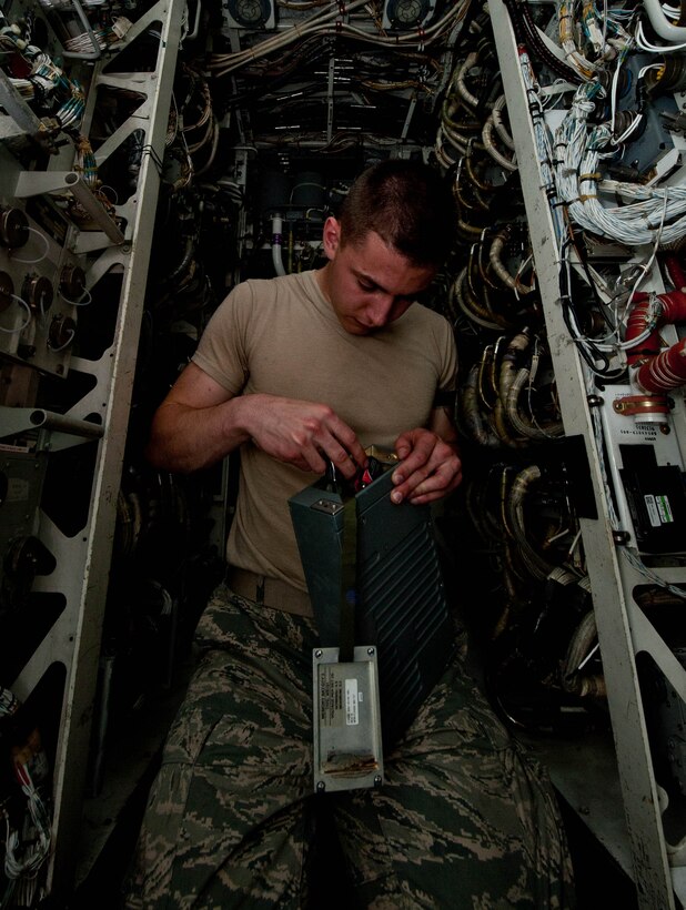 Airman 1st Class Jeffrey Merrill, 28th Aircraft Maintenance Squadron offensive avionic systems specialist, inspects a power control assembly battery for the central integrated test systems in a B-1 bomber during routine maintenance at Ellsworth Air Force Base, S.D., June 18, 2013. The system powers the B-1’s GPS, navigation, communication, sniper pod and radar capabilities.(U.S. Air Force photo by Airman 1st Class Zachary Hada/Released)