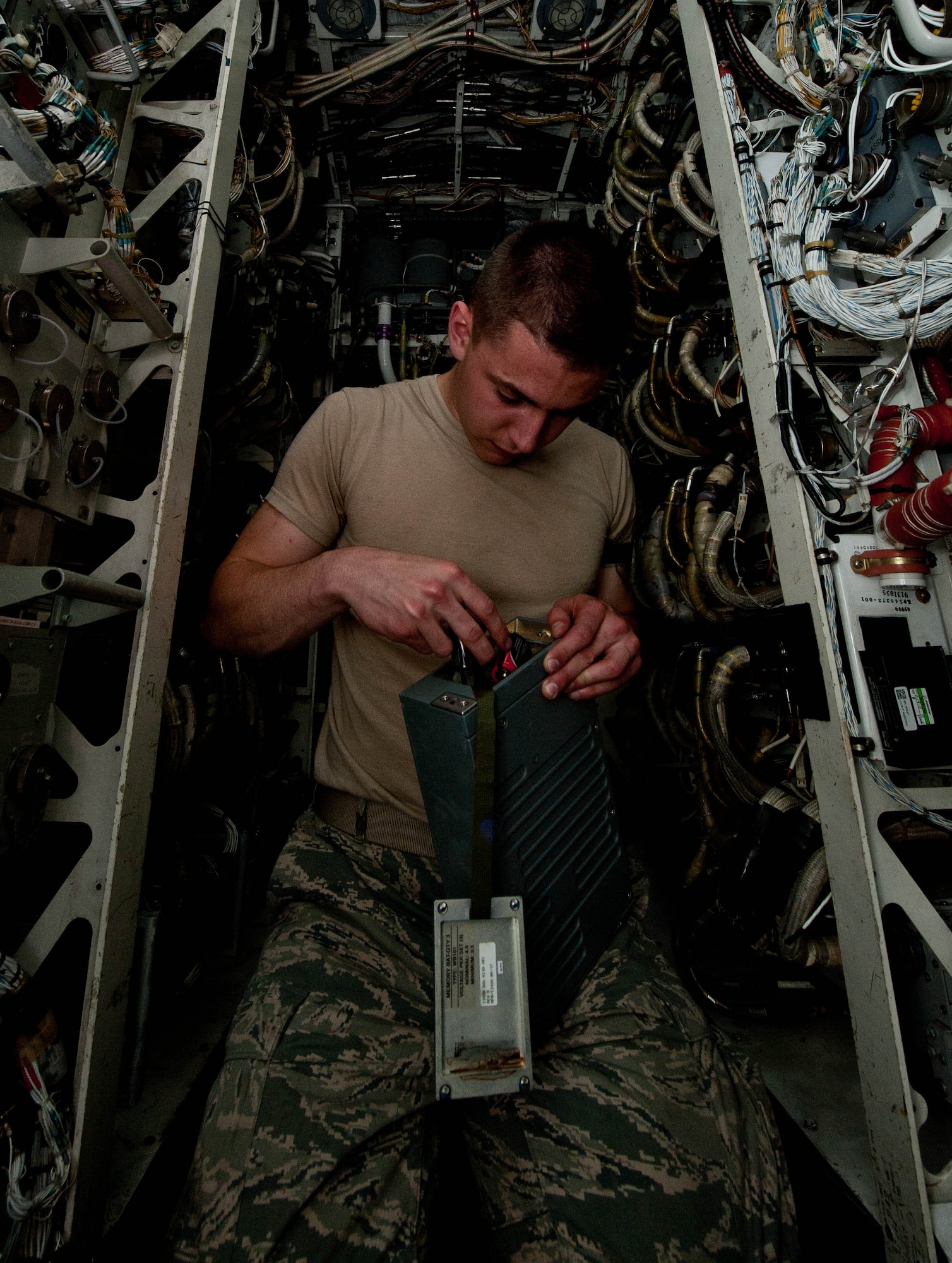Airman 1st Class Jeffrey Merrill, 28th Aircraft Maintenance Squadron offensive avionic systems specialist, inspects a power control assembly battery for the central integrated test systems in a B-1 bomber during routine maintenance at Ellsworth Air Force Base, S.D., June 18, 2013. The system powers the B-1’s GPS, navigation, communication, sniper pod and radar capabilities.(U.S. Air Force photo by Airman 1st Class Zachary Hada/Released)