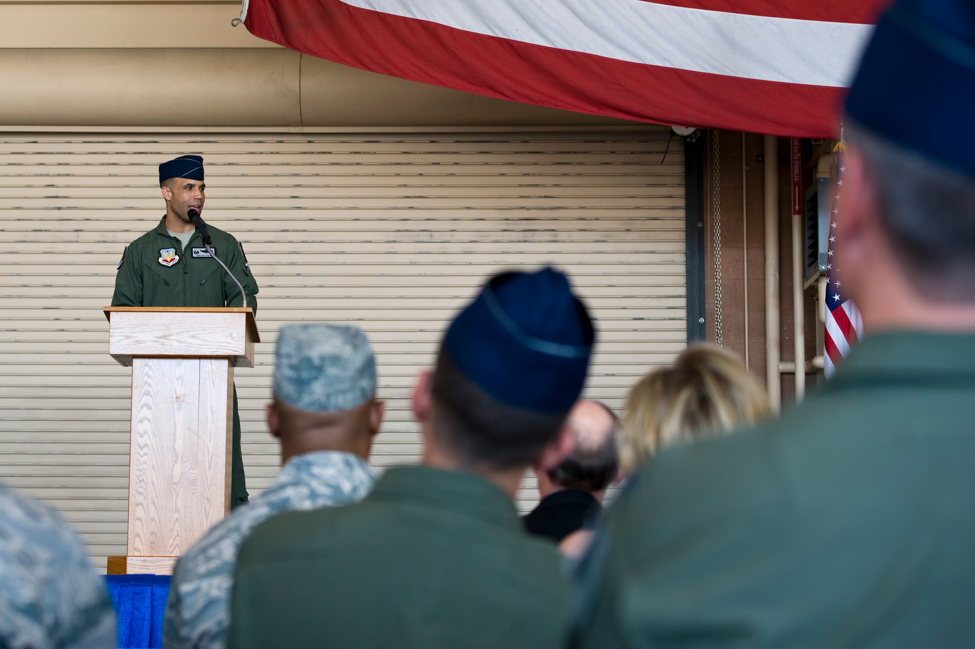 Lt. Col. Adrian Spain, U.S. Air Force Weapons School commandant, speaks to the crowd after accepting command during the USAFWS change of command ceremony at the F-22 Raptor hangar June 17, 2013, at Nellis Air Force Base, Nev. Spain is a command pilot with 1,800 fighter hours, including 129 in combat, in the F-15C Eagle and F-22A Raptor. (U.S. Air Force photo by Airman 1st Class Christopher Tam)