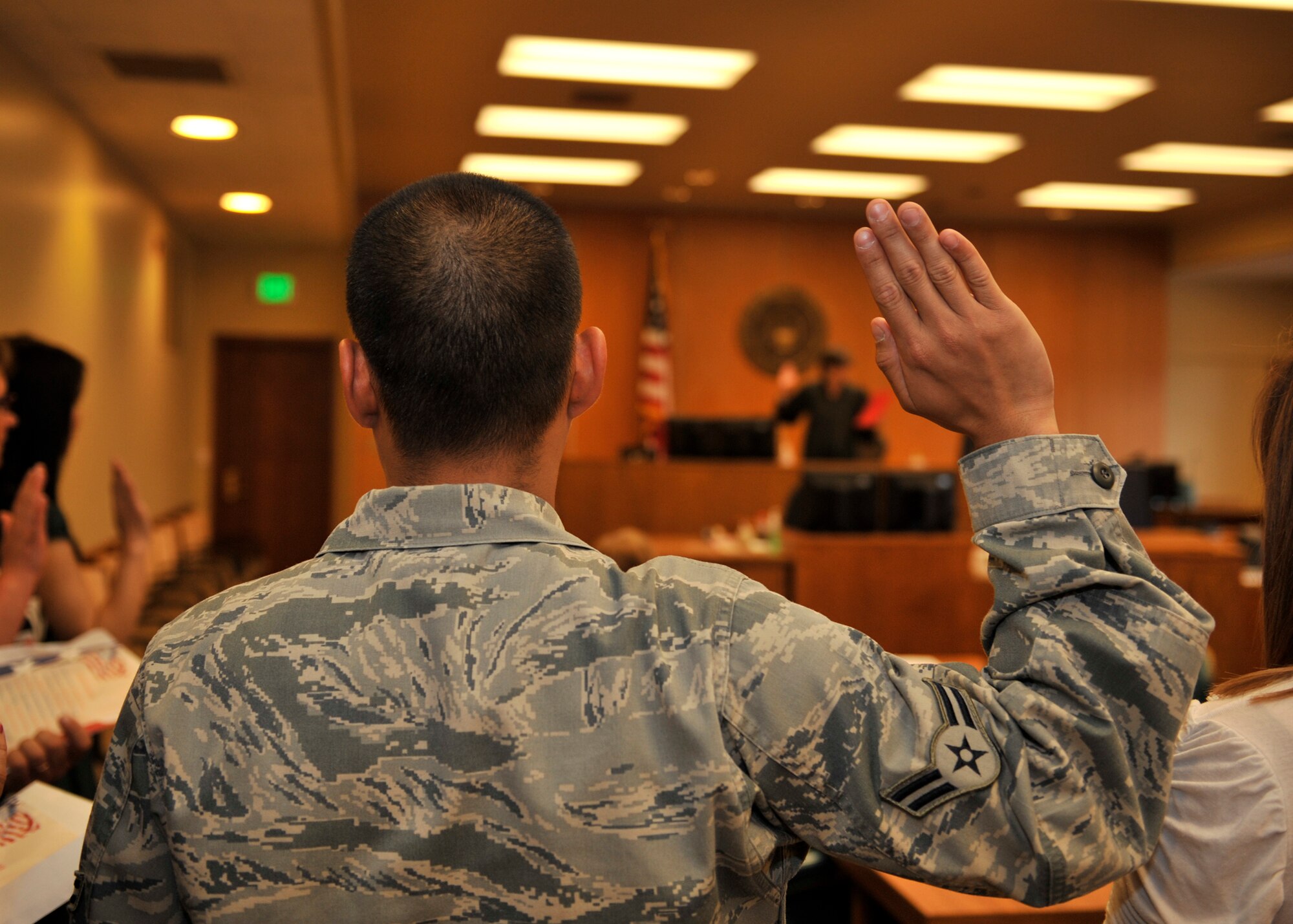Airman 1st Class Jillian Siojo, 92nd Logistics Readiness Squadron vehicle management and analysis journeyman, takes the Oath of Allegiance at the United States District Court, Eastern District of Washington with the honorable Cynthia Imbrogno, U.S. Magitrate Judge presiding in Spokane, Wash., June 18, 2013. Siojo is a native from the Philippines and moved to the U.S. eight years ago with his mother and younger brother for a better life. (U.S. Air Force photo by Staff Sgt. Michael Means/Released)